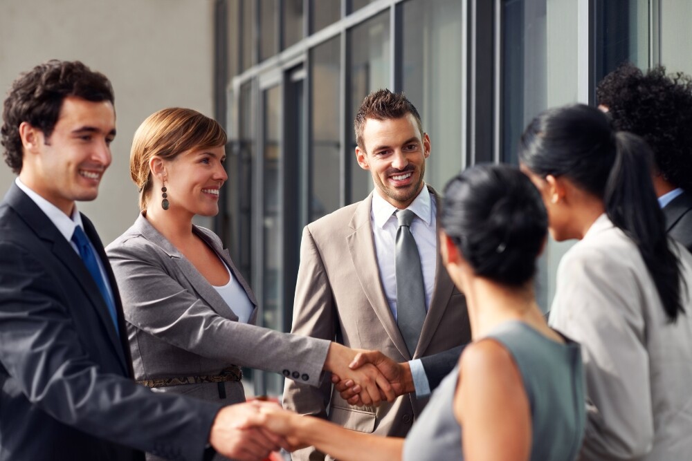business professionals shaking hands, symbolizing trust and the value of personal relationship marketing in healthcare practice growth